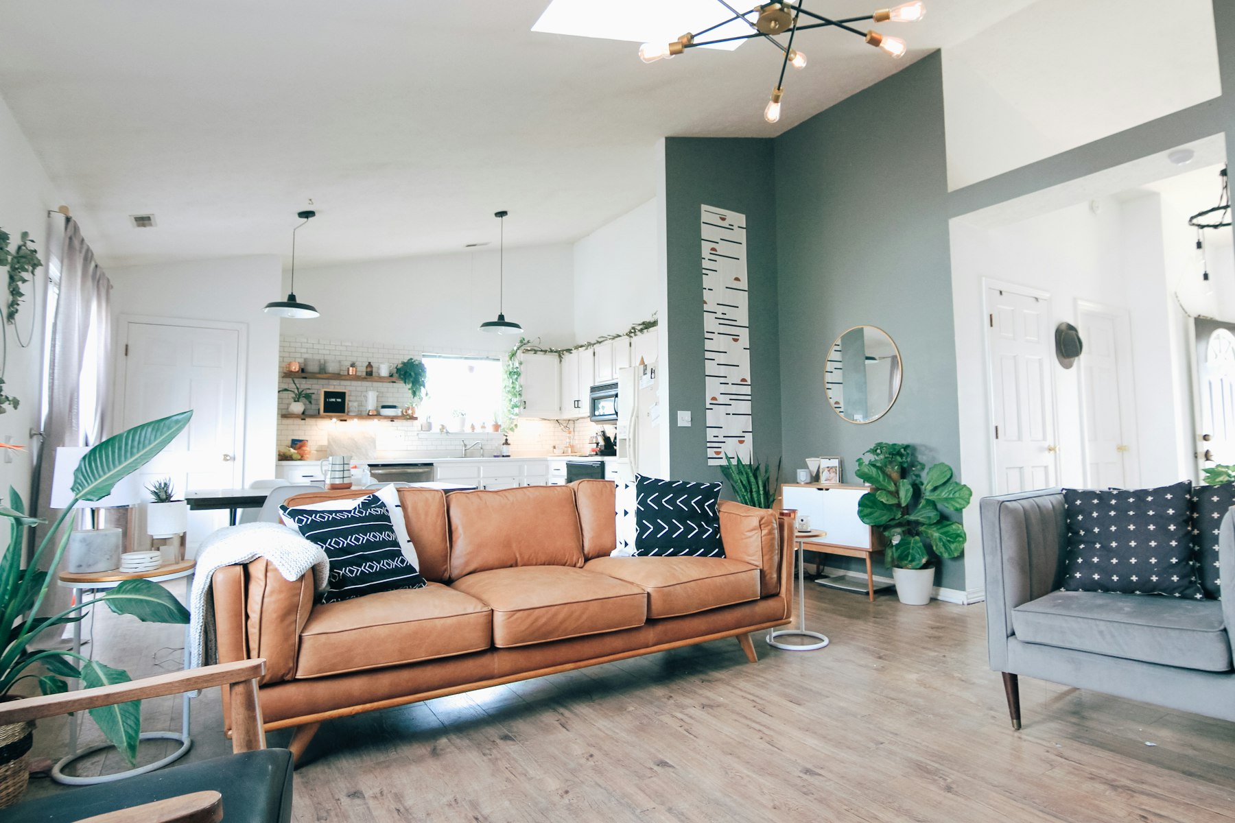Soft neutral room with layered seating, quiet art, and balanced morning light