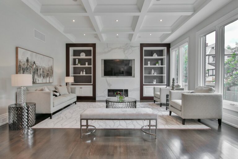 Formal living room with a large patterned area rug anchoring two sofas and a round glass coffee table