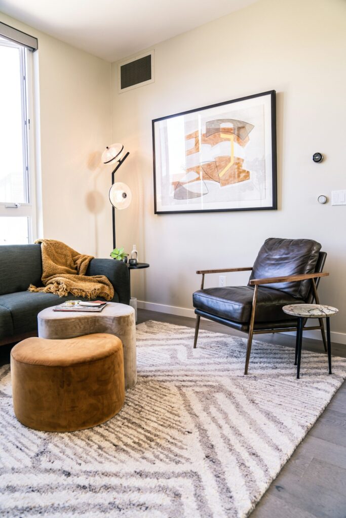 Living room with a substantial chair and an area rug defining the seating zone